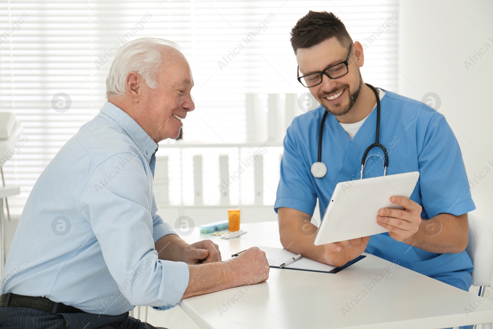 Photo of Senior man visiting doctor in modern office