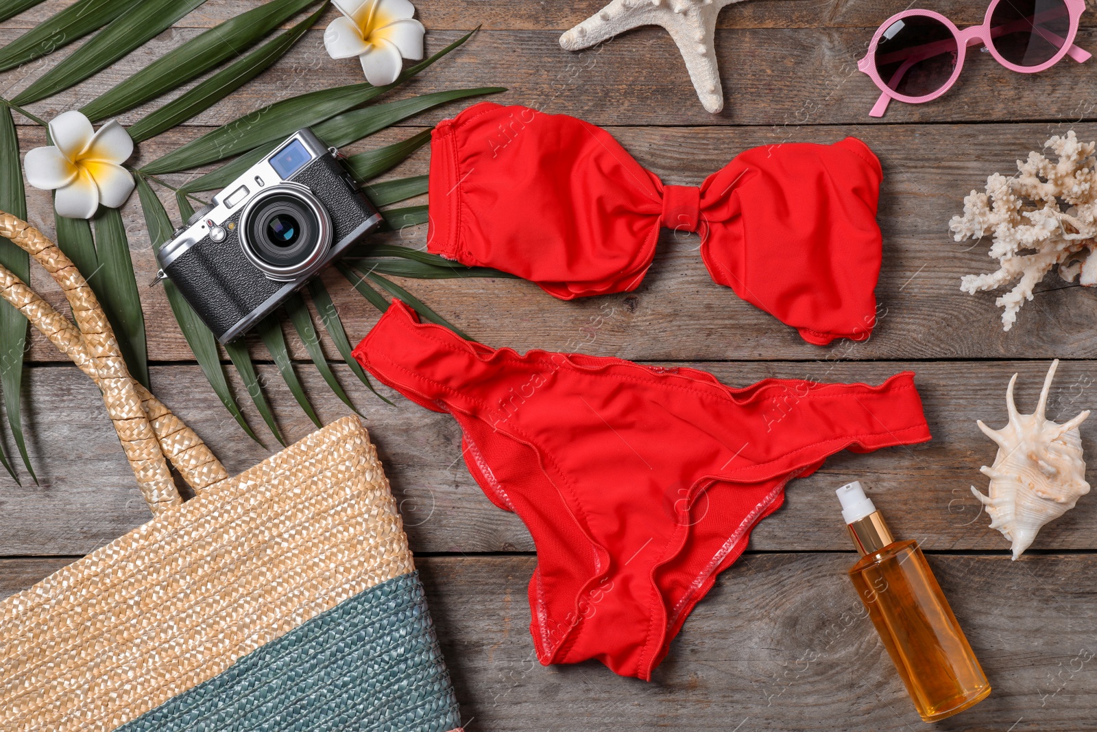 Photo of Flat lay composition with beach objects on wooden background