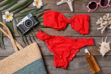 Photo of Flat lay composition with beach objects on wooden background