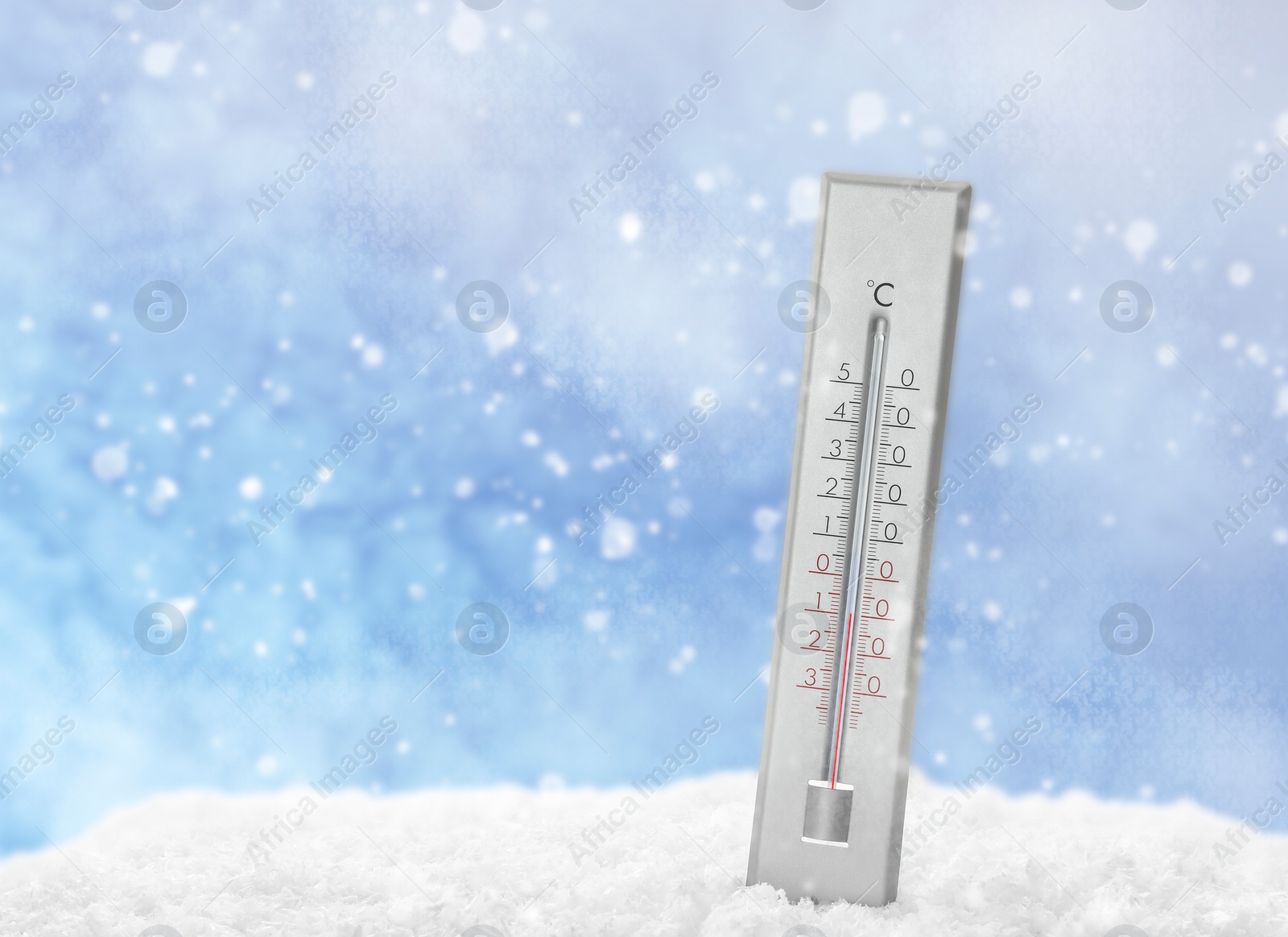 Image of Thermometer in snow showing temperature below zero outdoors on winter day