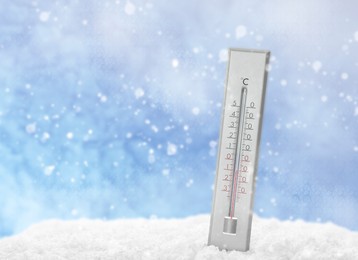 Image of Thermometer in snow showing temperature below zero outdoors on winter day