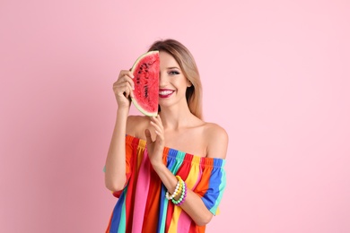 Pretty young woman with juicy watermelon on color background