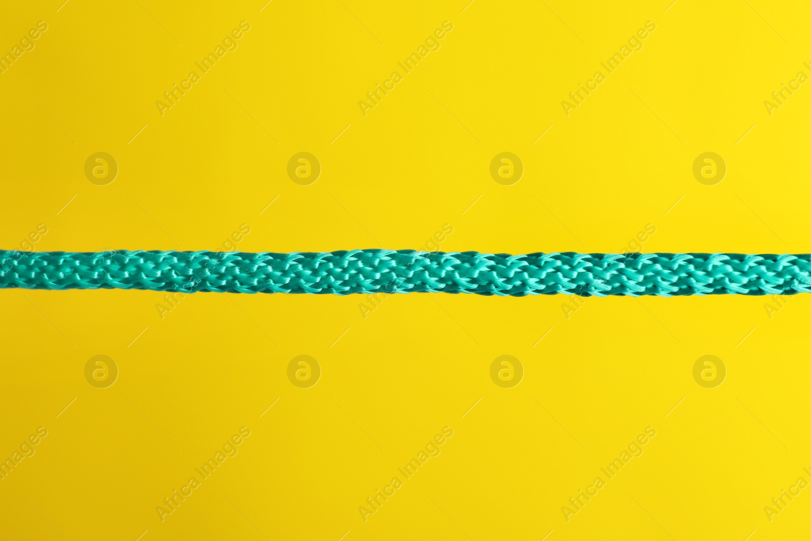 Photo of Strong straight blue rope on color background