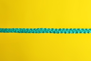 Photo of Strong straight blue rope on color background