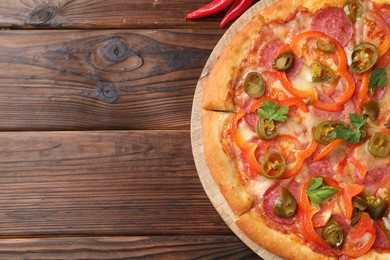 Photo of Delicious hot pizza Diablo on wooden table, flat lay. Space for text