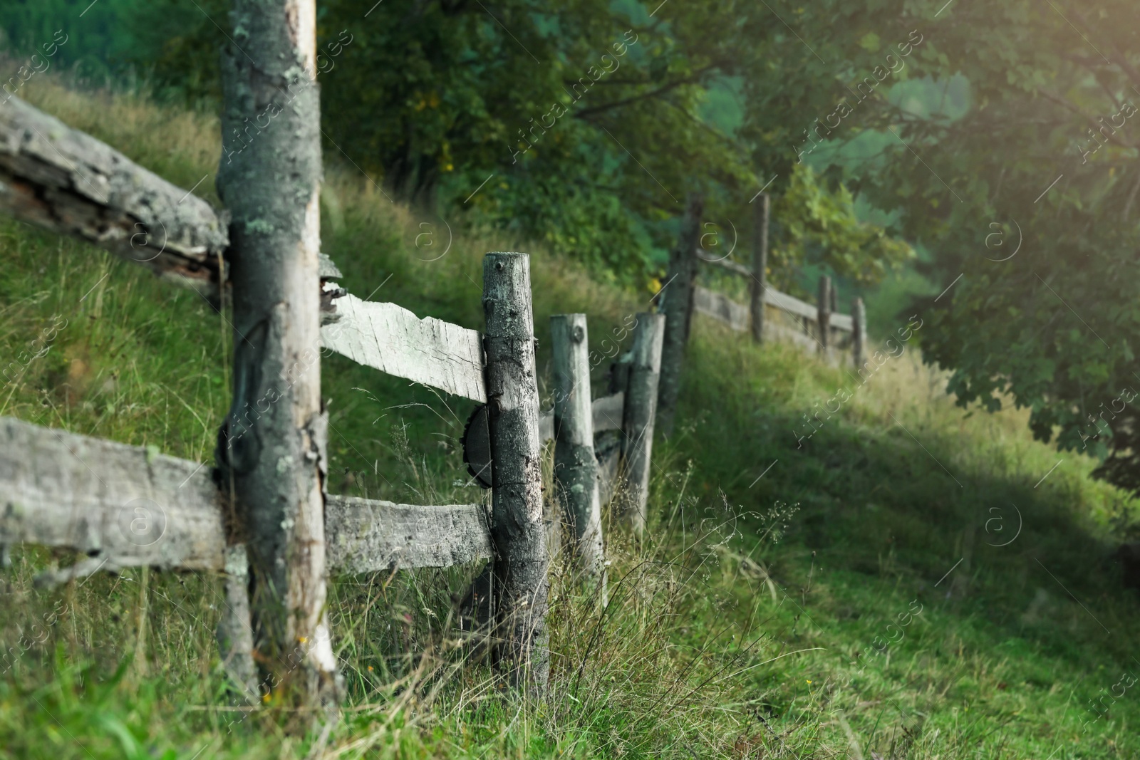 Photo of Beautiful countryside landscape with wooden fence on hill