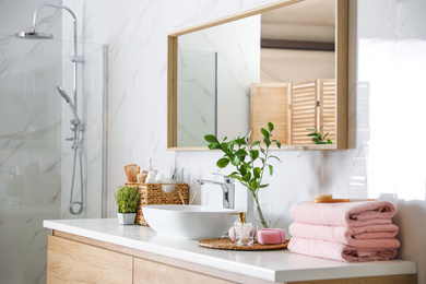 Photo of Large mirror over vessel sink in modern bathroom