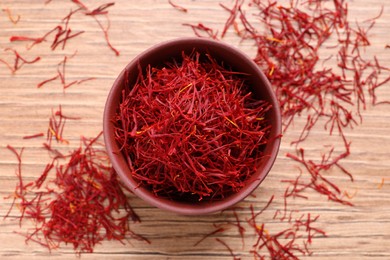 Dried saffron on wooden table, flat lay