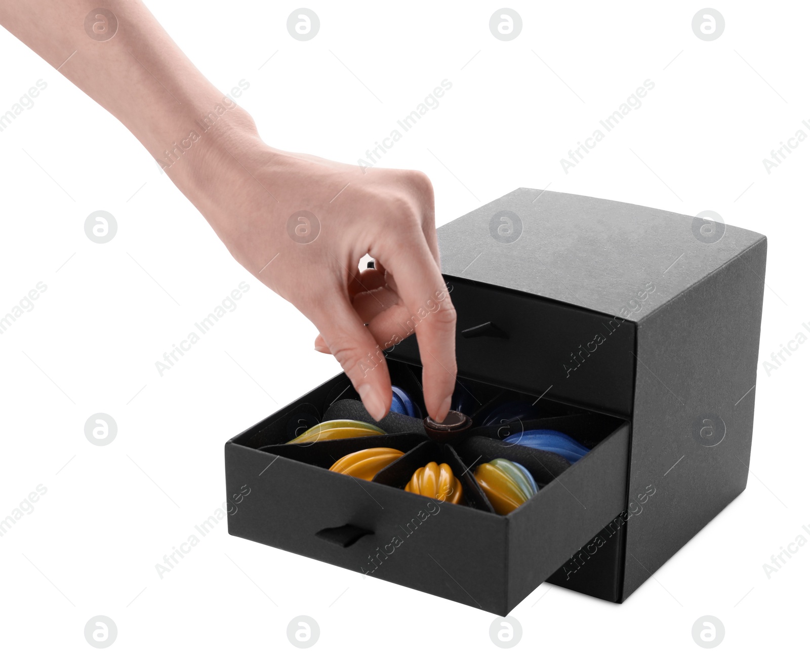 Photo of Woman taking delicious chocolate candy from black box on white background, closeup