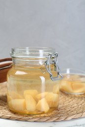 Photo of Delicious quince drink in jar on table