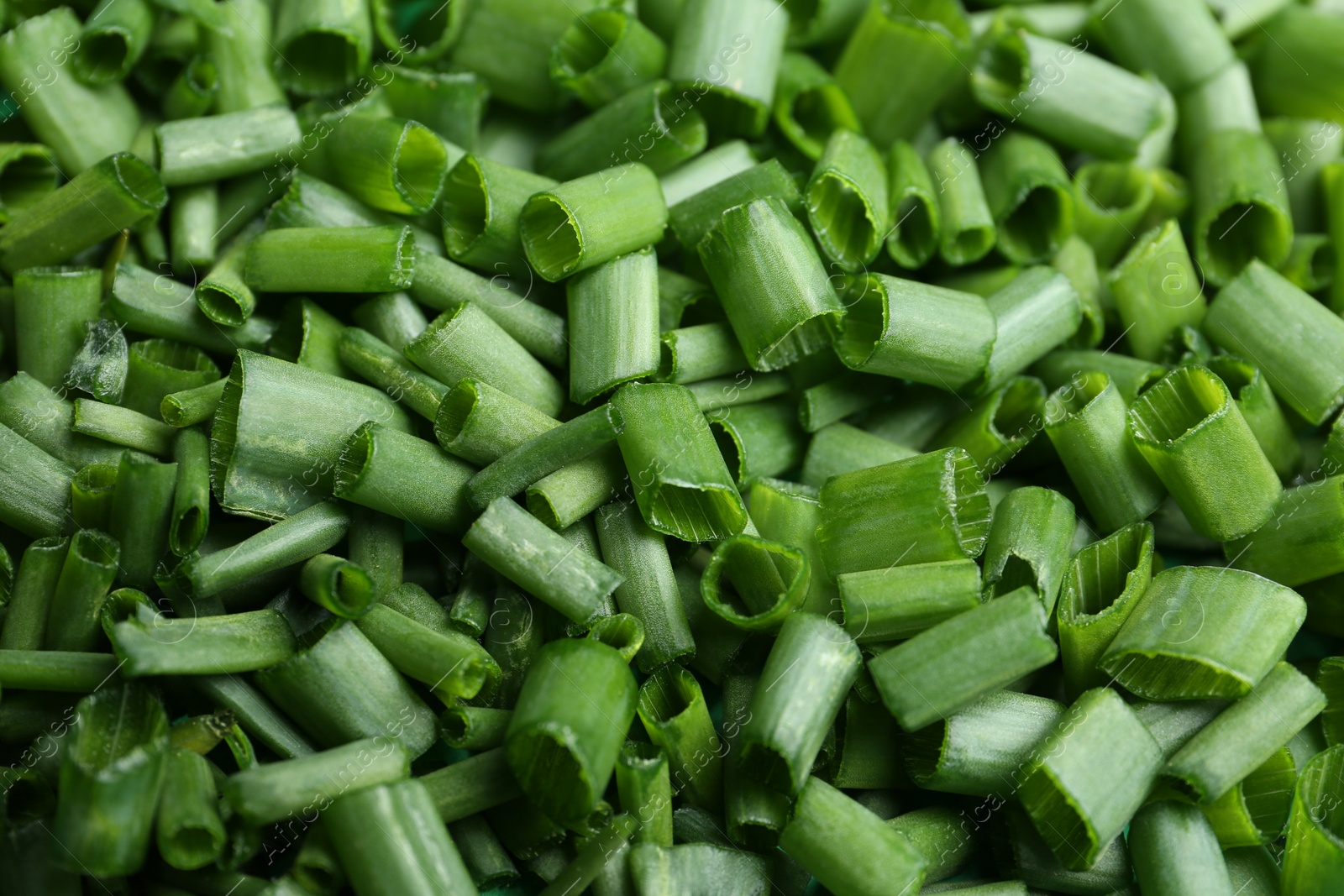 Photo of Cut green spring onions as background, closeup