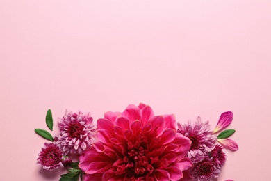 Photo of Flat lay composition with beautiful dahlia flowers and space for text on color background