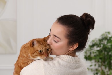 Beautiful woman with cute cat at home