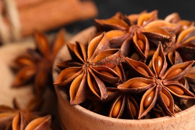 Photo of Aromatic anise stars in bowl, closeup view
