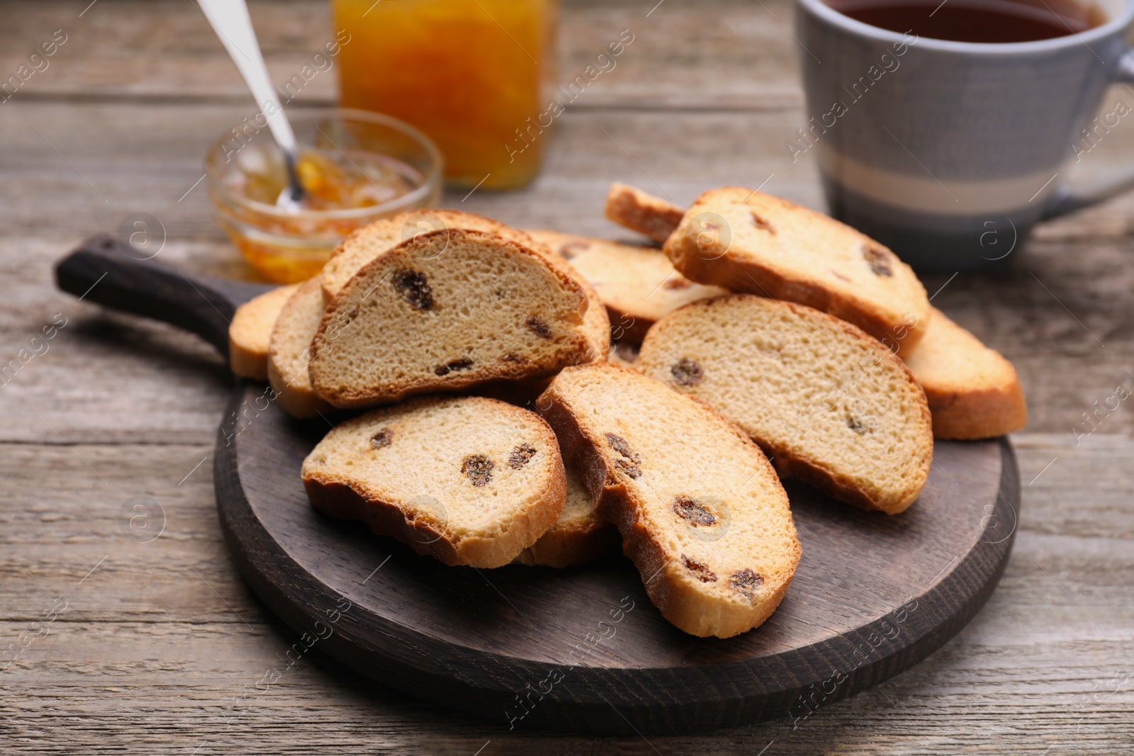 Photo of Sweet hard chuck crackers with raisins on wooden table