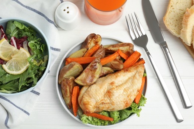 Photo of Delicious cooked chicken and vegetables on white wooden table, flat lay. Healthy meals from air fryer