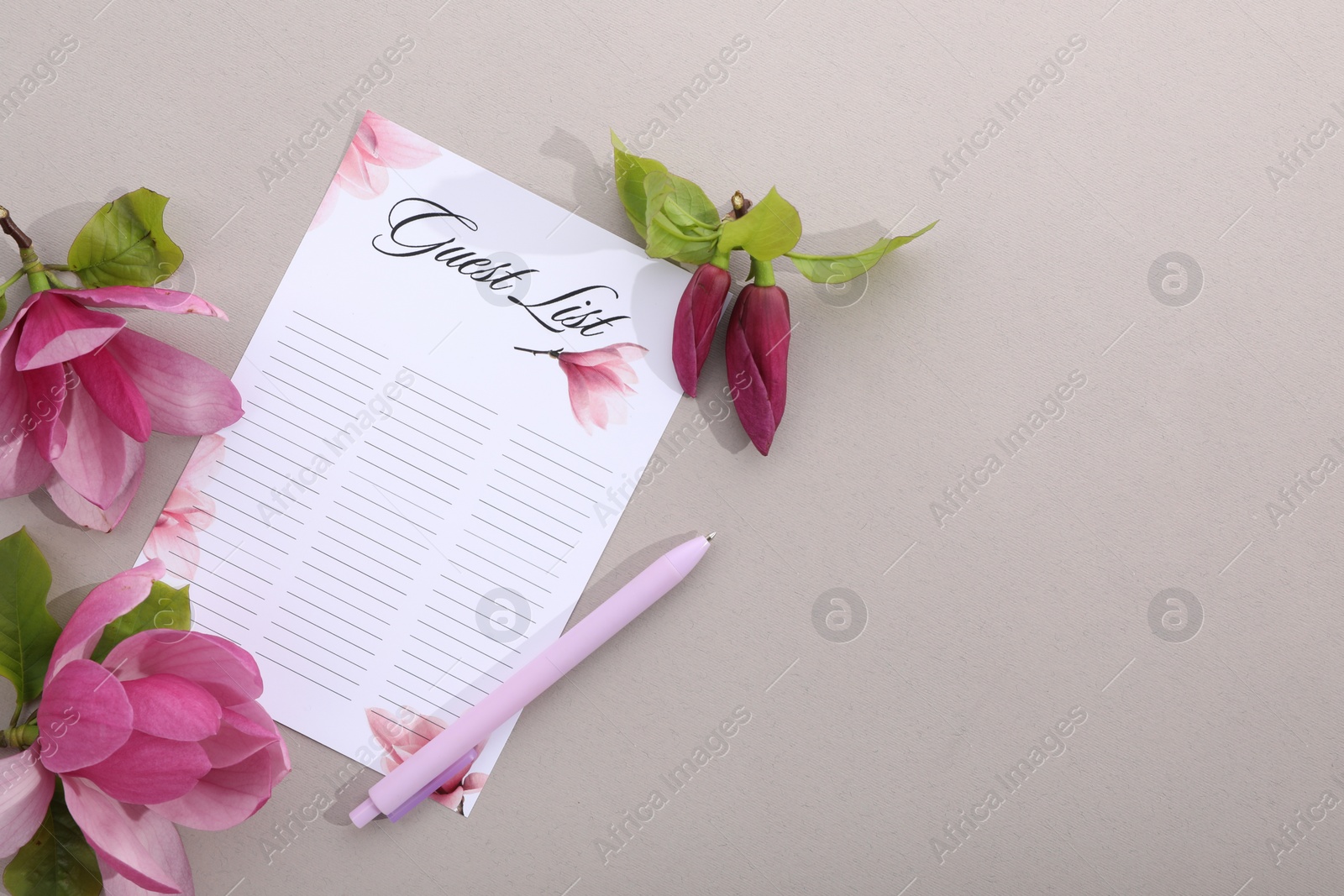 Photo of Guest list, pen and beautiful flowers on grey background, flat lay. Space for text