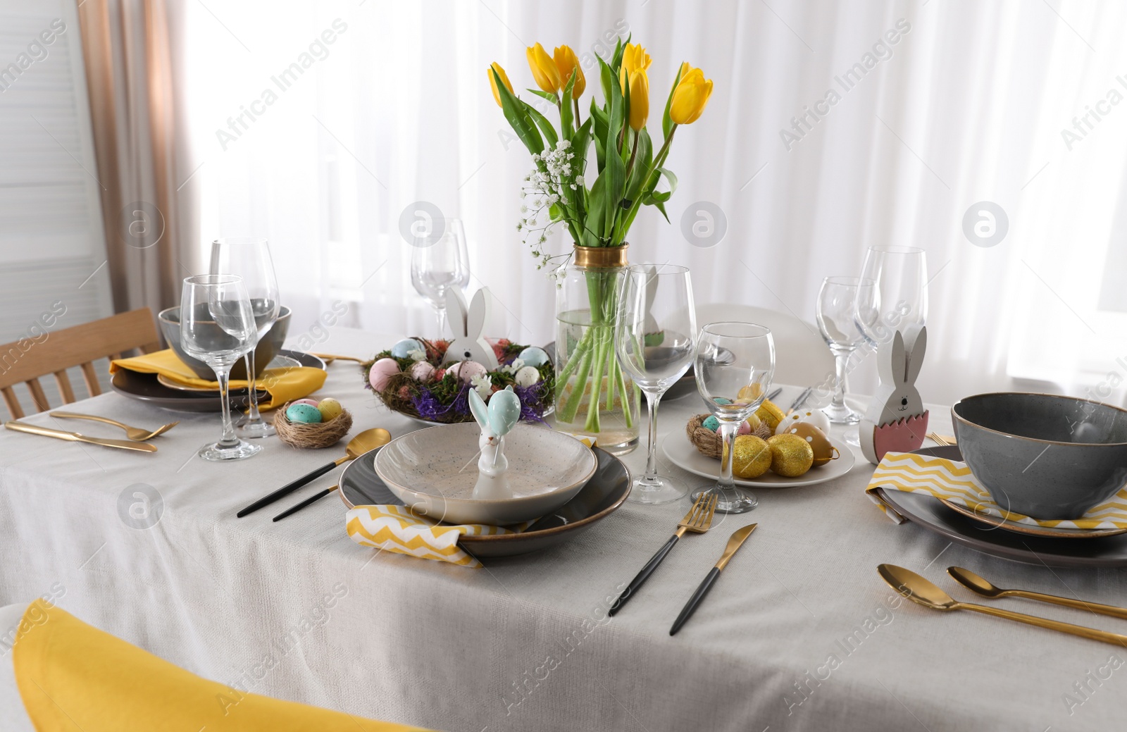 Photo of Beautiful Easter table setting with festive decor indoors