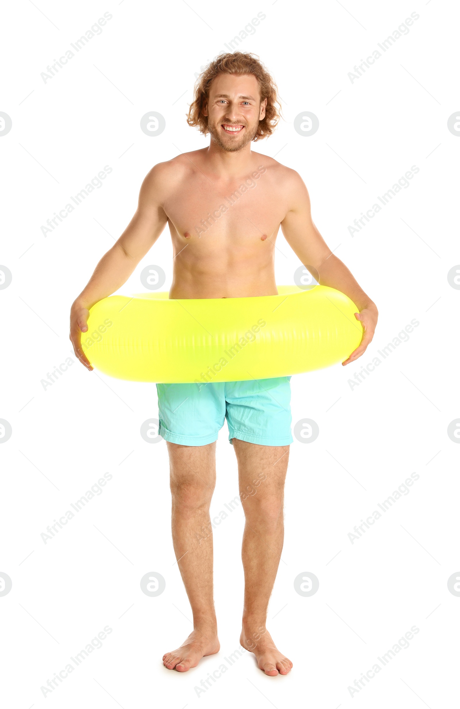 Photo of Attractive young man in swimwear with yellow inflatable ring on white background