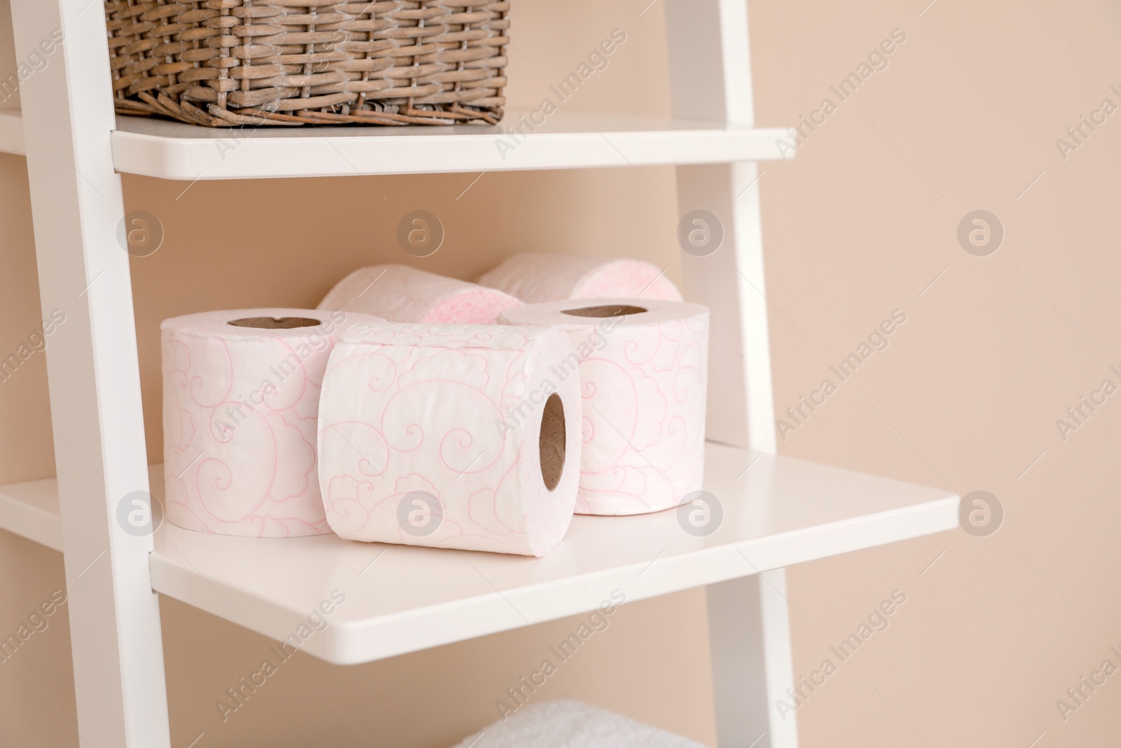 Photo of Toilet paper rolls on shelving unit in bathroom