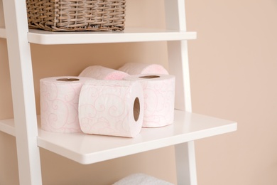 Photo of Toilet paper rolls on shelving unit in bathroom