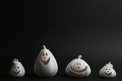 Photo of Jack-o-Lantern candle holders on black background. Halloween decor