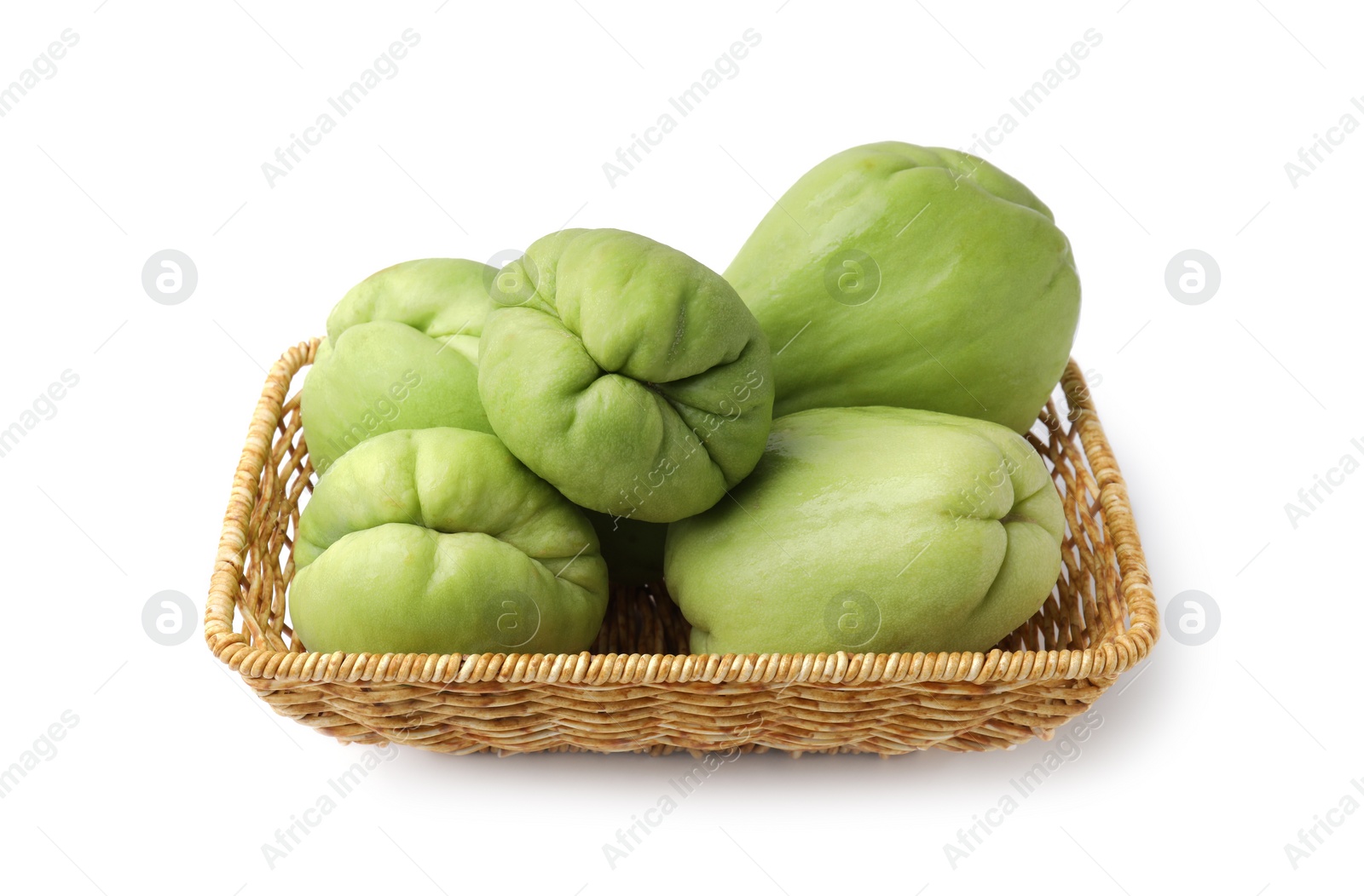 Photo of Fresh green chayote in wicker basket isolated on white