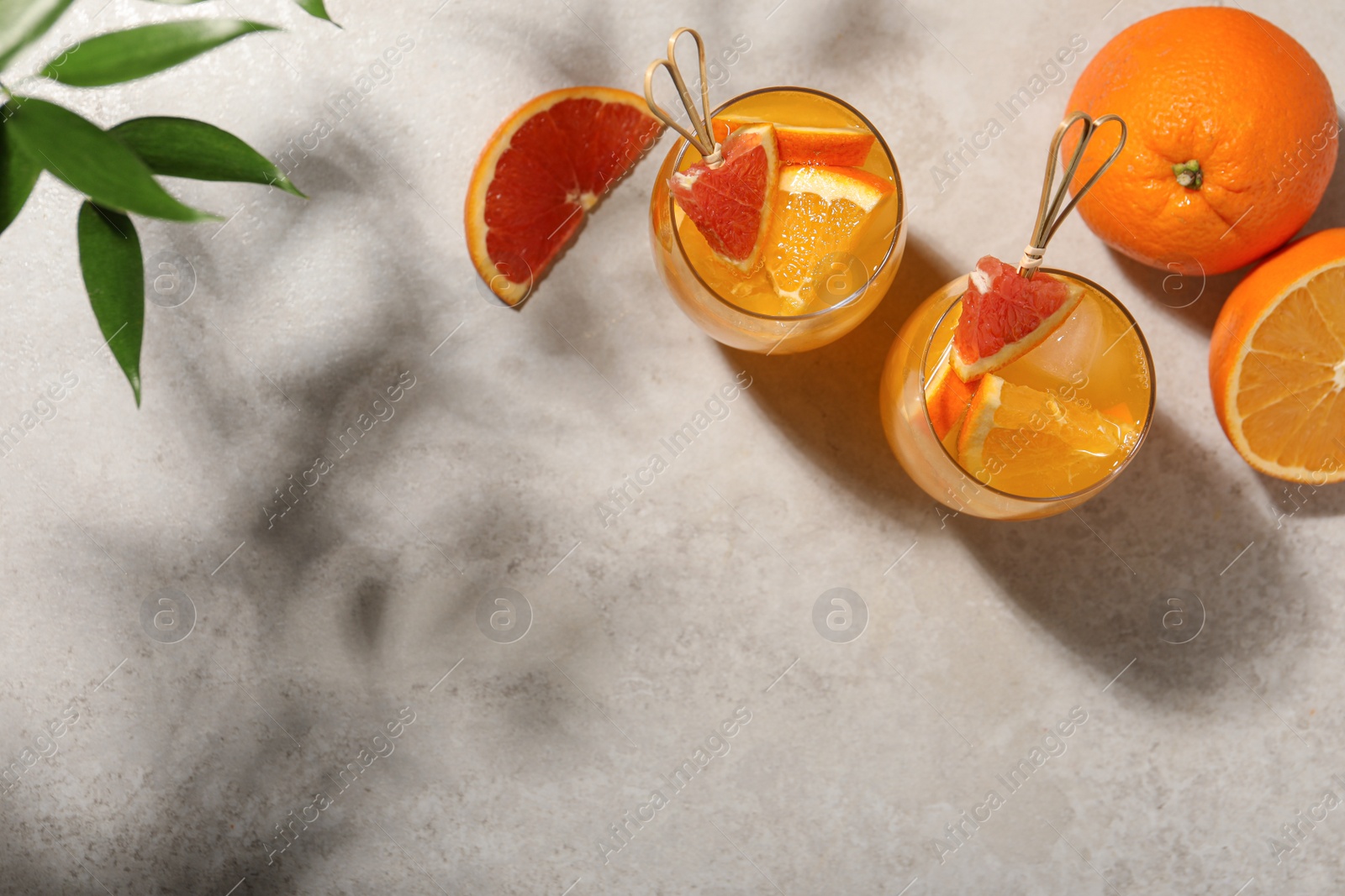 Photo of Delicious orange soda water on light table, flat lay. Space for text