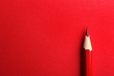 Photo of Color pencil on red background. Space for text
