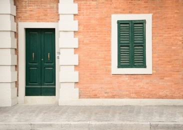 Photo of Beautiful building with wooden door on city street