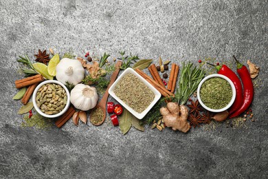 Photo of Flat lay composition with different natural spices and herbs on grey table