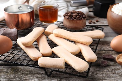 Photo of Tasty cookies and other ingredients for tiramisu on wooden table