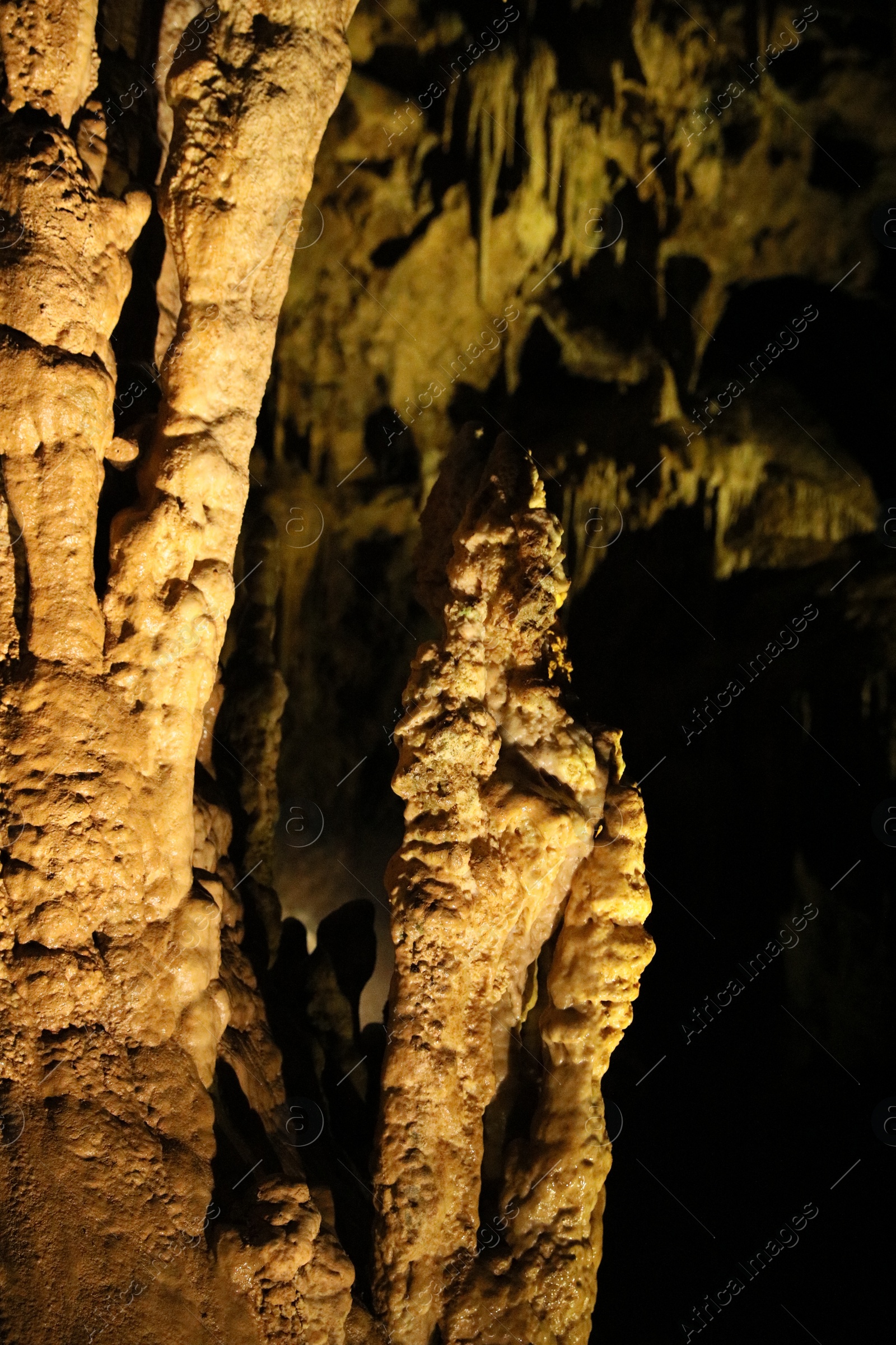 Photo of Picturesque view of many stalactite and stalagmite formations in cave