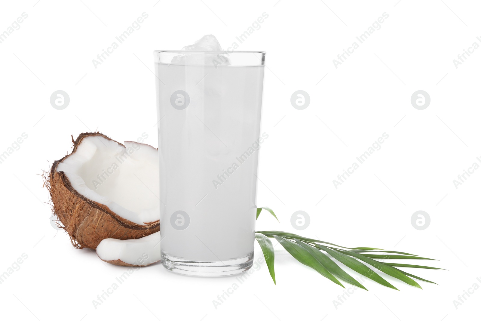 Photo of Glass of coconut water, ice cubes, leaf and nut isolated on white