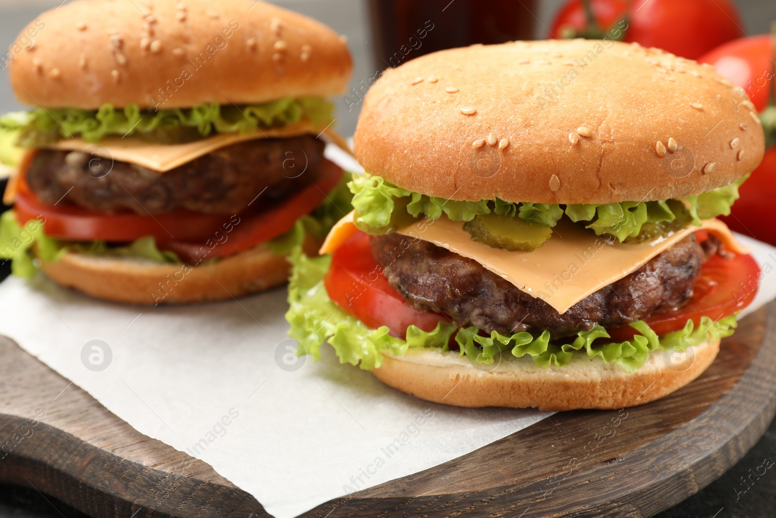 Photo of Tasty hamburgers with patties on table, closeup