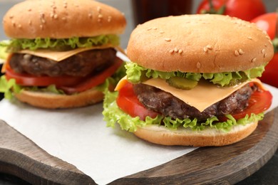 Photo of Tasty hamburgers with patties on table, closeup