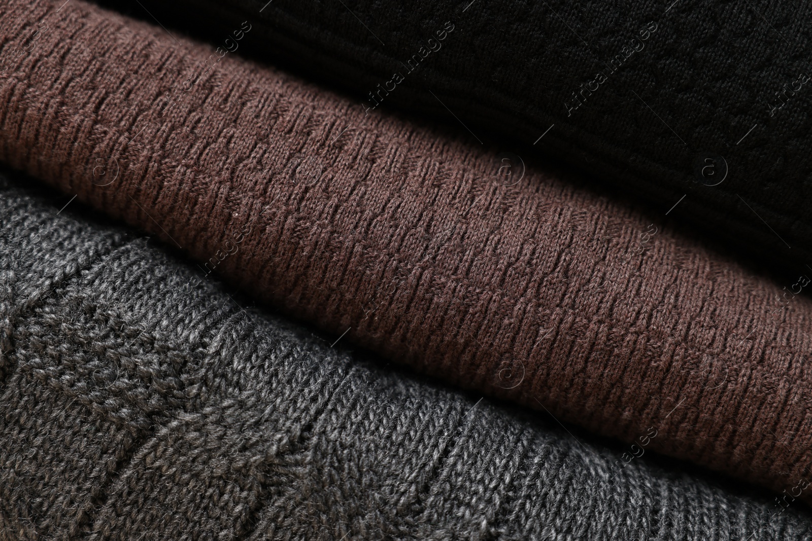 Photo of Closeup view of different casual folded sweaters as background