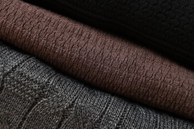 Photo of Closeup view of different casual folded sweaters as background