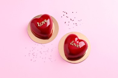 St. Valentine's Day. Delicious heart shaped cakes on light pink background, flat lay