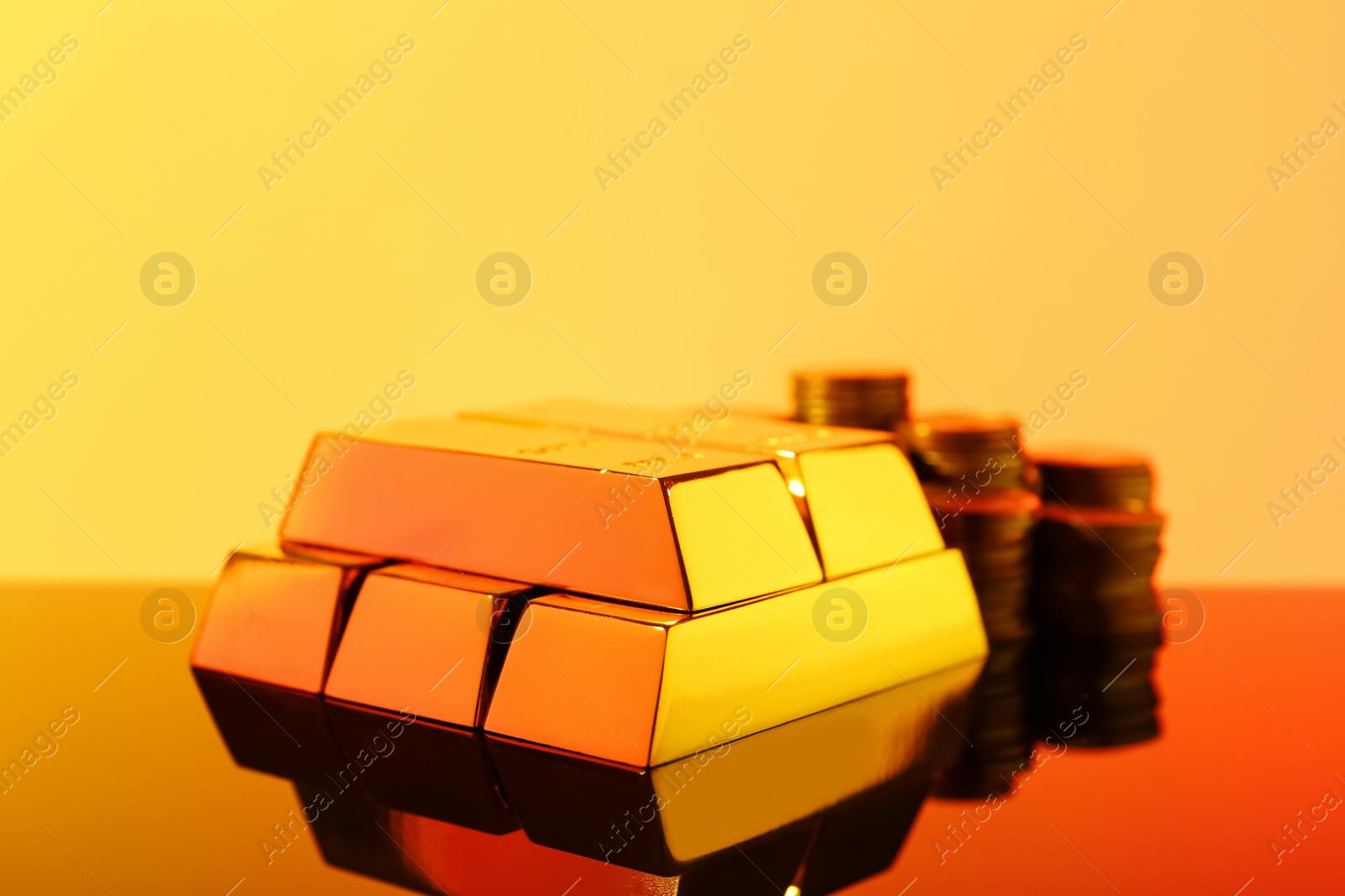 Photo of Precious shiny gold bars on mirror surface