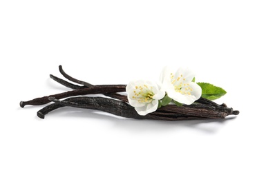 Photo of Vanilla sticks and flowers on white background