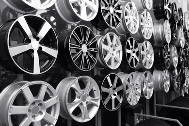 Image of Alloy wheels on rack in auto store. Black and white effect