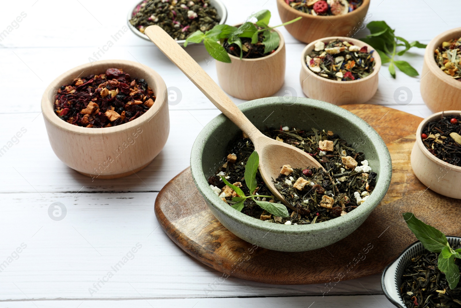 Photo of Many different herbal teas on white wooden table