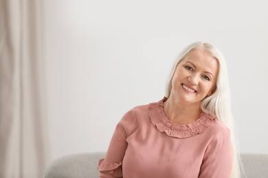 Photo of Portrait of beautiful older woman against blurred background with space for text