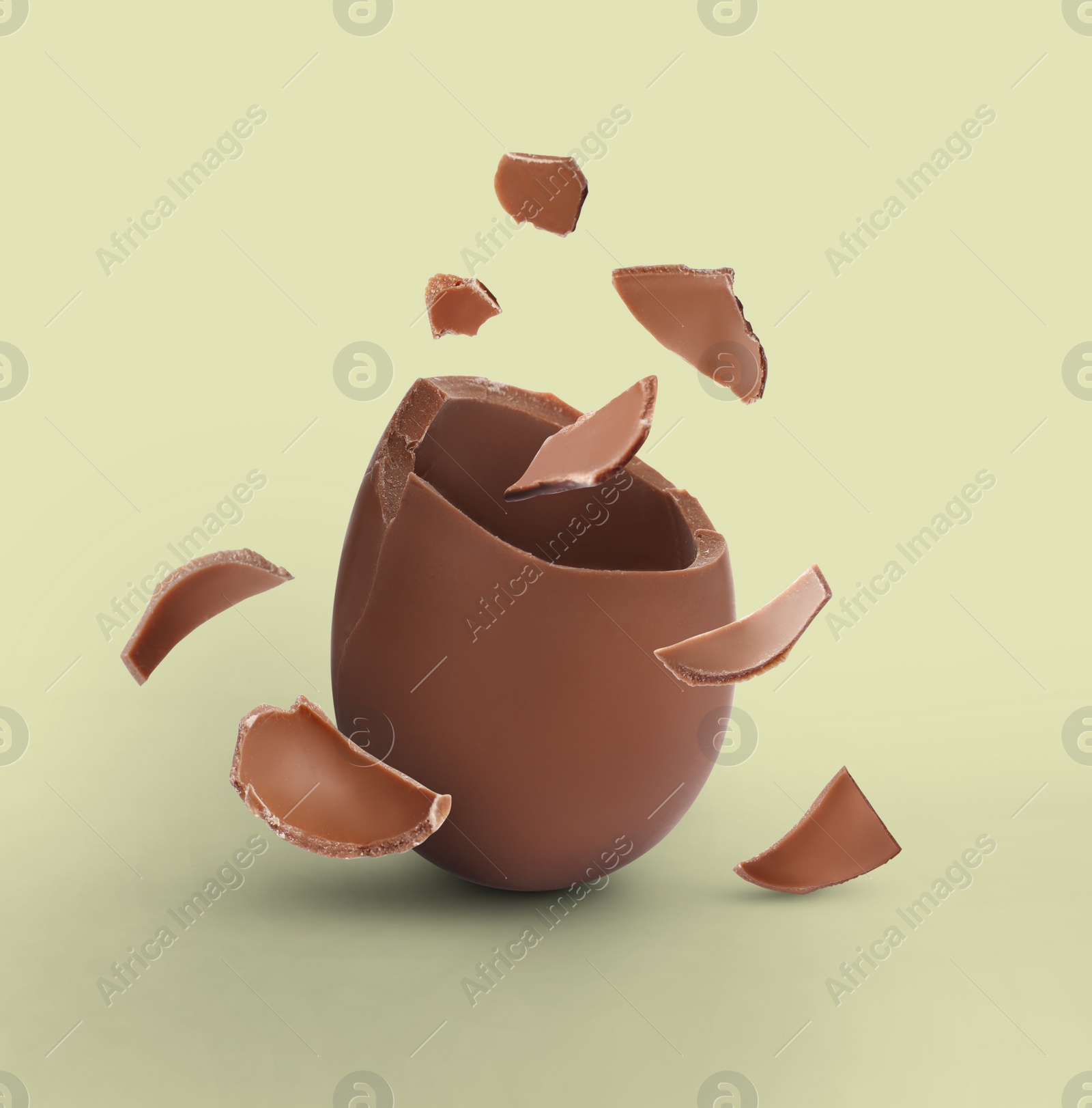 Image of Exploded milk chocolate egg on beige background