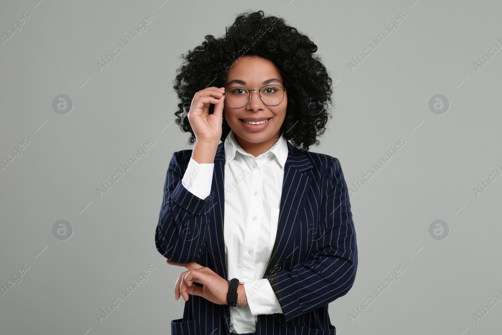 Photo of Young businesswoman in formal outfit on grey background