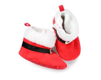 Photo of Cute small booties on white background, top view. Christmas baby clothes
