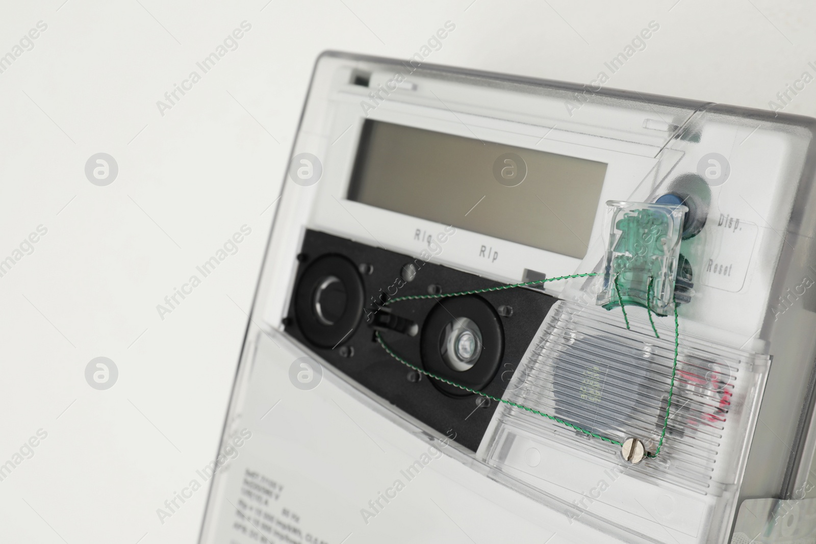 Photo of Electric meter on white background, closeup. Measuring device