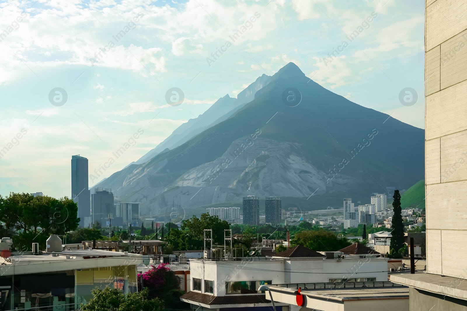 Photo of Picturesque view of mountains and city with skyscrapers