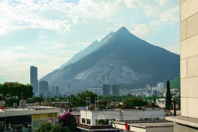 Picturesque view of mountains and city with skyscrapers